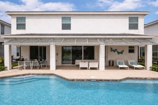 Modern two-story white house with pool and covered patio area
