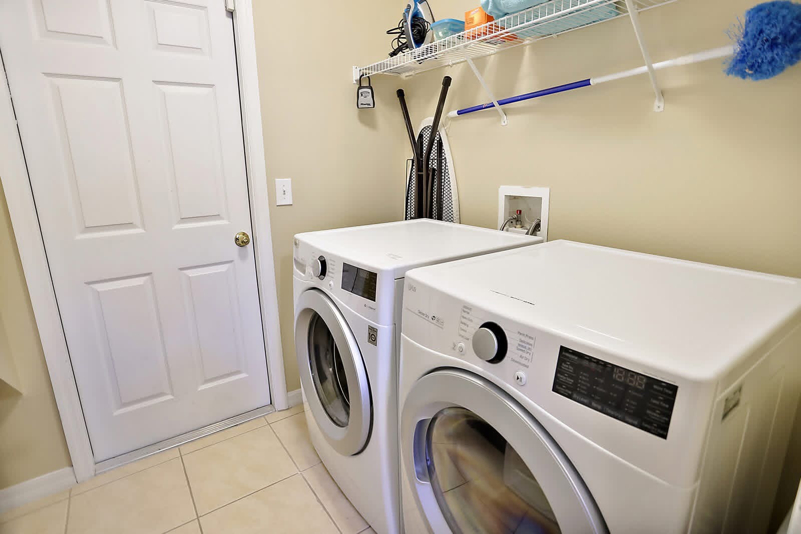 Modern laundry room with two front-load washing machines and organized wall storage